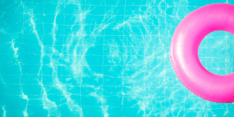 Pinker Schwimmring im türkisfarbigen Wasser